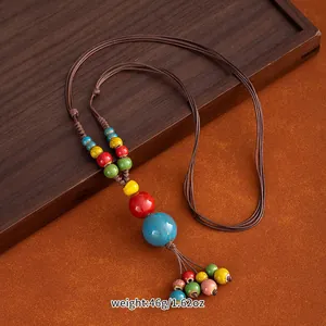 Macro view of handmade ethnic ceramic bead necklace with colorful porcelain pendants