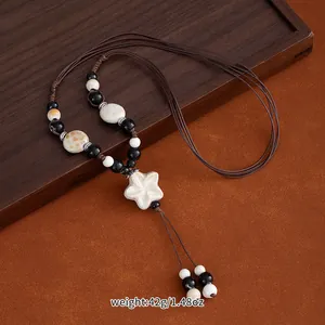 Handmade ethnic style long ceramic necklace with star pendant and brown braided cord