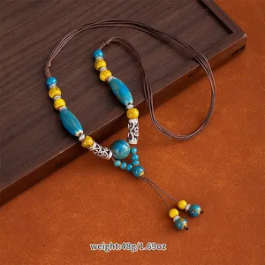 Detailed view of handmade ethnic ceramic bead necklace with vintage woven rope
