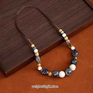 Close-up of a handmade ethnic Jingdezhen ceramic bead necklace on a braided cord
