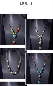 Collection of four unique ethnic ceramic beaded necklaces displayed on black busts.