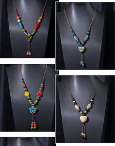Detail view of handmade ethnic style ceramic necklaces featuring colorful beads and woven ropes