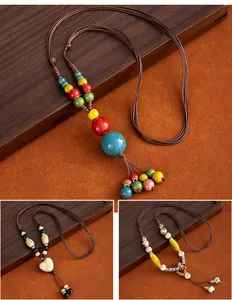 Detailed view of Chinese style ceramic beads on a long woven cord sweater chain