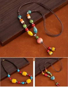 Close-up detail of ethnic style long necklaces with colorful ceramic beads and woven rope