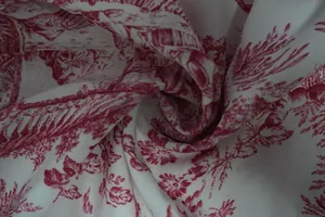 Macro detail of elegant red Toile de Jouy scenic print fabric showing fine weave texture