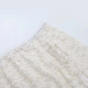 Gros plan détaillé de l'encolure en dentelle florale blanche d'un haut dénudé