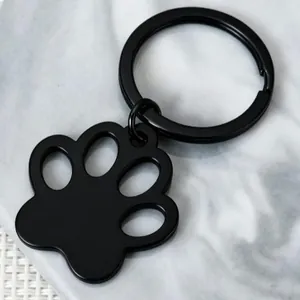 Minimalist black stainless steel paw print keychain for pet tags and personalized DIY pendants.