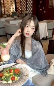 Asian model wearing a striped cotton linen shawl with sparkling sequins in a restaurant
