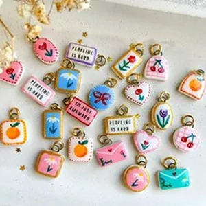 Macro view of colorful hand-painted style DIY fruit and flower charms for jewelry