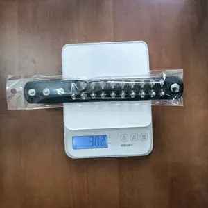 Detailed weight measurement of a punk black leather bracelet with silver spikes, weighing 30.2g