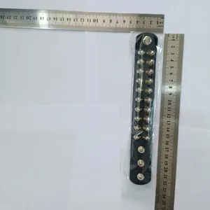 Detail view of black leather punk rivet bracelet with metal spikes and measurement rulers.