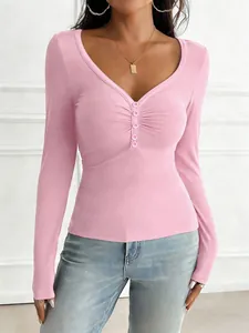 Detailed view of women's pink long-sleeved T-shirt featuring a ruched button-down front.