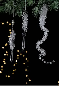 Transparent acrylic icicle hanging ornaments on a pine branch for Christmas tree decor