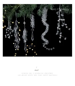 Close-up of clear acrylic crystal icicle ornaments hanging on a Christmas tree.