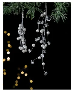 Close-up of elegant Christmas tree hanging string with pearls and clear acrylic crystals