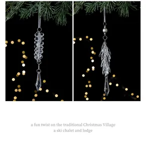 Detailed view of clear crystal icicle Christmas ornaments with warm bokeh background