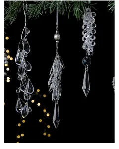 Elegant detailed close-up of clear acrylic icicle ornaments hanging on a Christmas tree