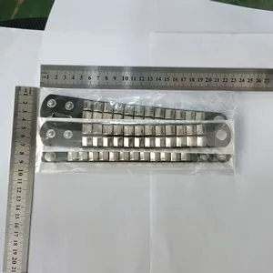 Close-up of three studded punk bracelets measured with a ruler for scale
