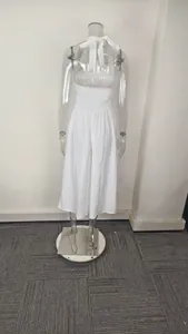 Rear view of a white halter neck midi dress with smocked waist detail on a mannequin