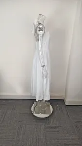 Side profile view showing the silhouette of a white halter neck backless midi dress