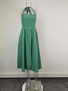 Full view of an elegant green halter neck backless midi dress on a clear mannequin