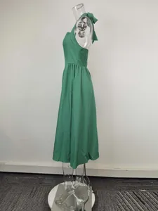 Detailed side view of an elegant green halter neck backless midi dress on mannequin