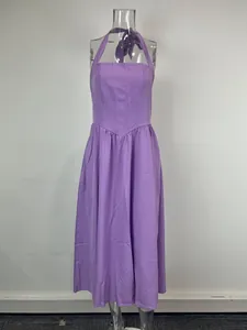 Elegant purple halter neck backless midi dress with a flowing skirt on mannequin.