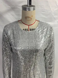 Close-up detail of a silver sequined long-sleeve bodycon dress on a tailoring mannequin