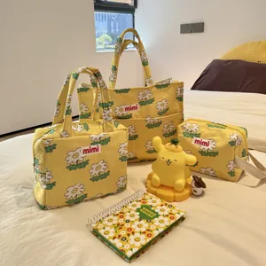 Detail view of yellow daisy printed multi-functional storage bags in three sizes.