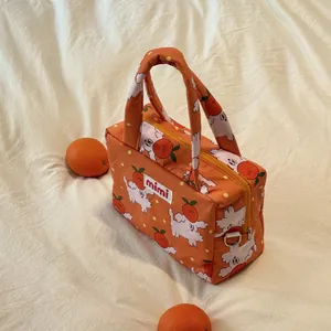 Cute orange bag with cartoon dog and fruit print on cream textured background