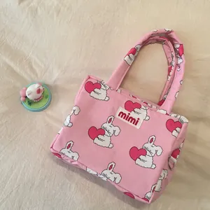 Cute pink large capacity handbag with cartoon rabbit print for mothers and babies.