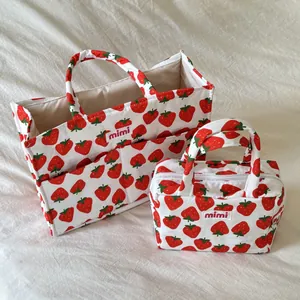 A pair of cute strawberry print mommy bags featuring a large tote and a small zipper pouch