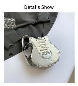 Detail view of a stylish silver guitar-shaped crossbody bag with rivet accents