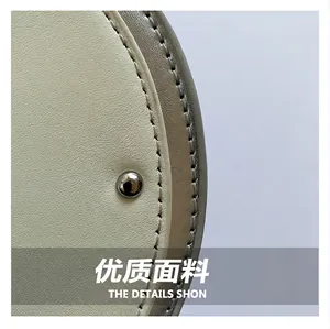 Macro detail view of guitar-shaped crossbody bag with textured leather and silver rivet