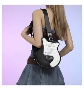 Detail of a stylish guitar-shaped crossbody bag with black and white rivets worn by a model