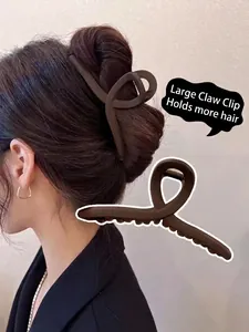 Macro detail of a large matte brown hair claw clip designed for thick bun styling