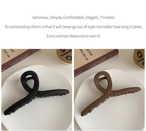 Detailed view of two large matte hair claw clips in black and brown side by side