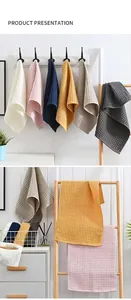 Set of soft waffle weave cotton towels in assorted colors displayed in a modern bathroom