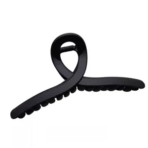 Large black matte hair claw clip with elegant twisted design for thick hair updo styles