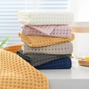Stacked waffle weave pure cotton towels set in assorted colors with soft textured finish