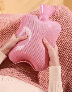 Close-up of hands holding a pink ribbed hot water bottle for soothing heat therapy