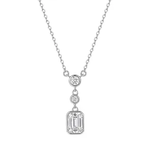 Macro detail of S925 sterling silver necklace with three emerald-cut zircon pendants.