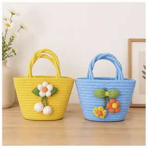 Two hand-woven cotton rope basket handbags featuring cute floral and cherry designs