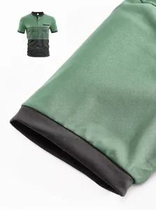Close-up of the sleeve cuff and fabric texture on a green men's casual polo shirt.