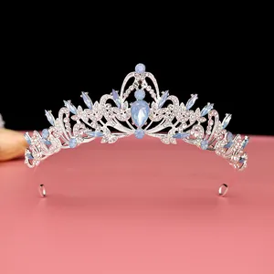 Elegant silver-toned bridal tiara with vintage blue crystal detailing for weddings.
