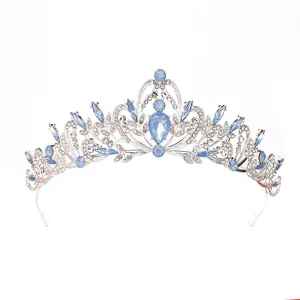 Detailed view of silver Baroque crown featuring elegant blue gemstones and rhinestones