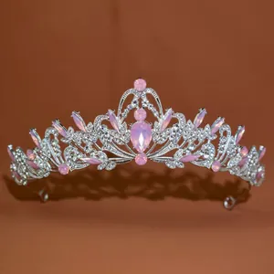 Close-up of vintage Baroque bridal tiara with pink crystals and silver metalwork.
