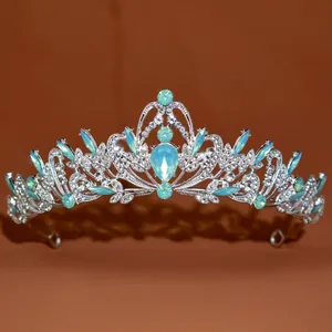 Macro detail view of a baroque style silver tiara with intricate light blue stones
