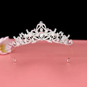 Close-up of an elegant silver Baroque crown featuring intricate crystal details.
