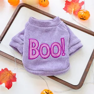 Close-up of a purple Halloween pet sweater featuring glittery Boo embroidery detail.